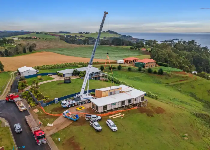 Tasbuilt Homes modular building sections delivered by truck and positioned on site in Ulverstone with the help of Cranes Combined.