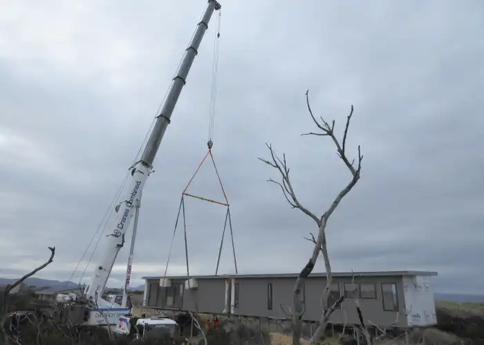 Tasbuilt Homes module being carefully craned into position alongside another module for the Unique Coastal Retreat project in Dolphin Sands, Tasmania.