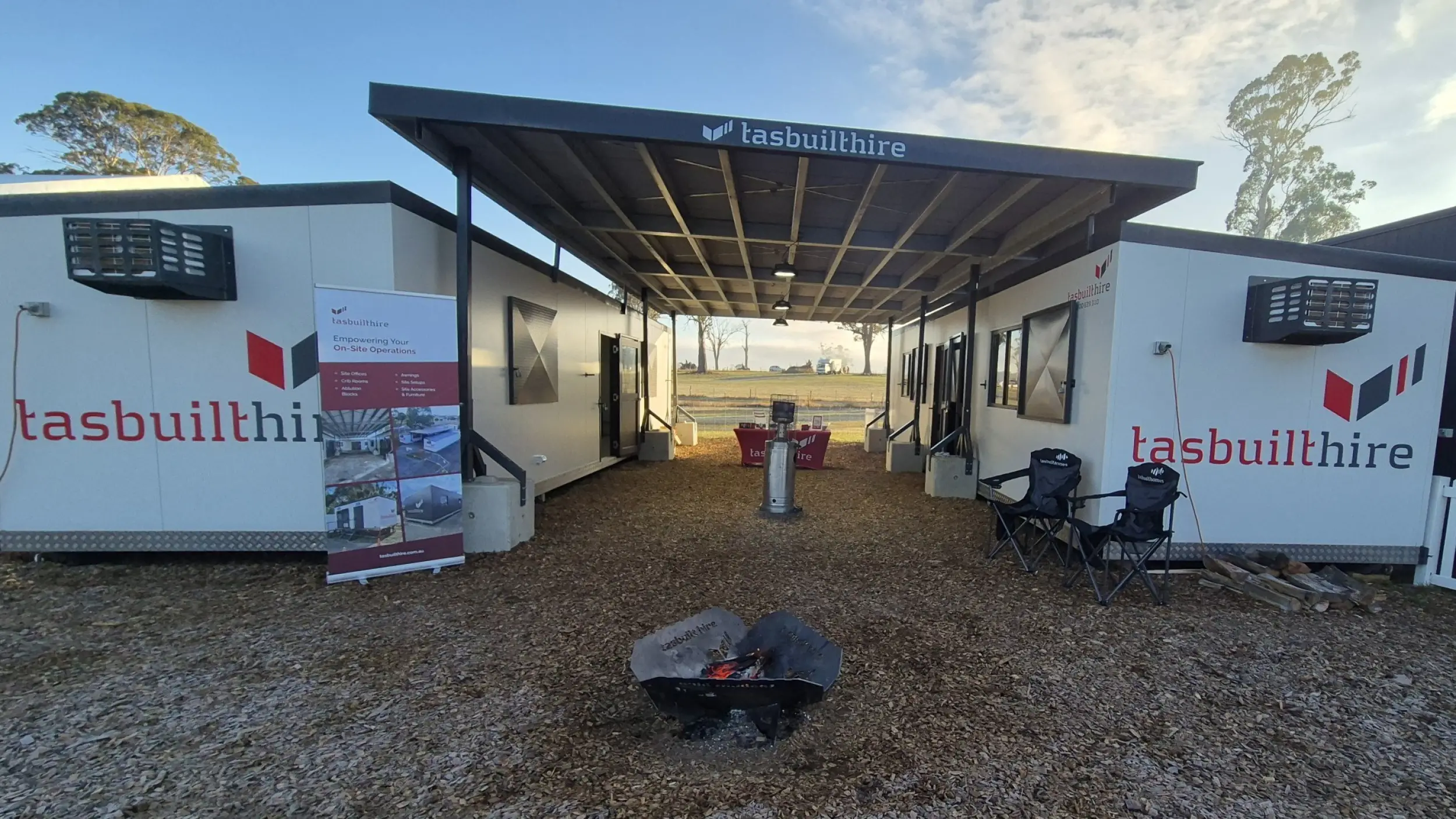 Two Tasbuilt Hire modular units set up as a demo display with a covered roofing structure installed between them.