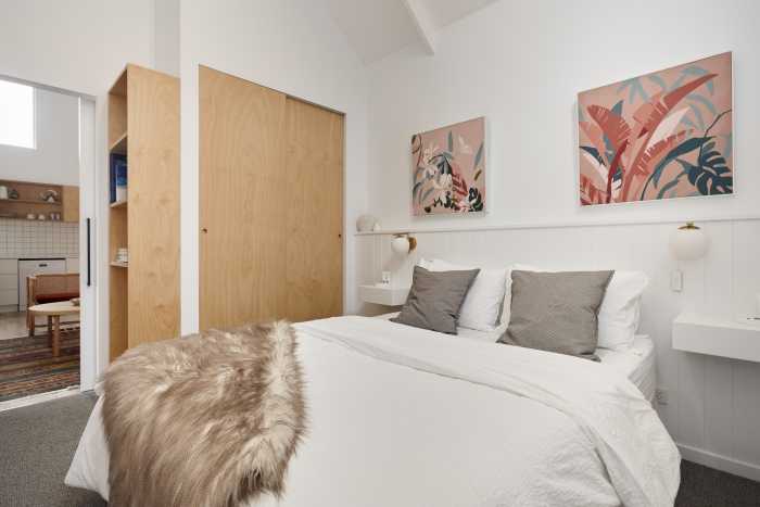 Tasbuilt Homes bedroom with larege wooden sliding cupboards