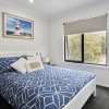 Large double bed room with blue quilt cover