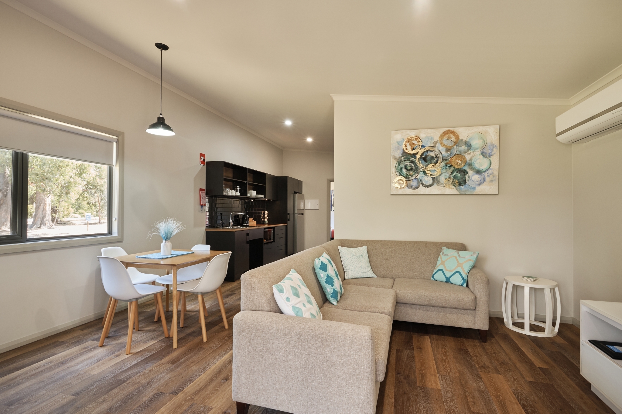 Exterior view of Tasbuilt Commercial’s luxury holiday cabins at NRMA Holiday Park Port Arthur, Tasmania, featuring convict brick panels, spa baths, and outdoor living areas.