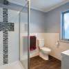 Bathroom with tiled niche and blue walls of prefabricated home