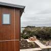 Timber cladding with grey gutter finishes