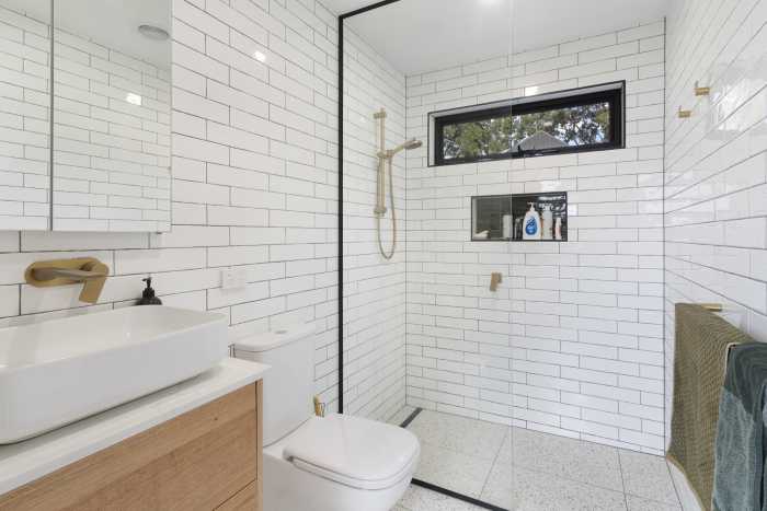 Black and White Tiled Bathroom with Gold Tapware and Tiled Shower Niche