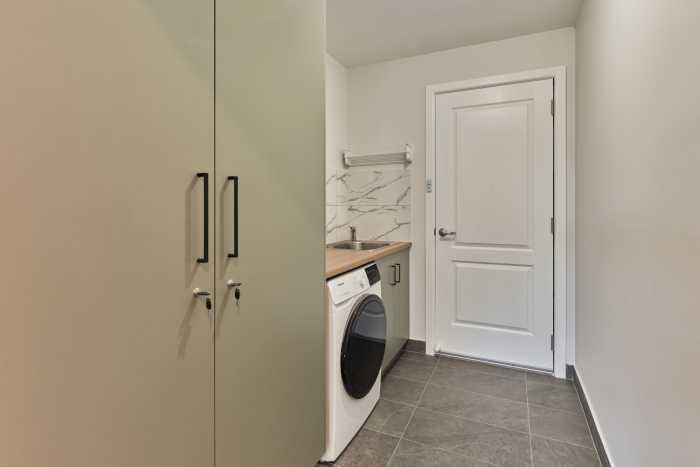 Stylish Green Laundry with Marble Tiles