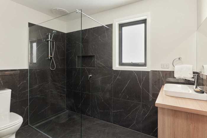 Black Tiled Bathroom with Large Walk-In Shower