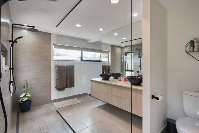 Adjoining Shower and Toilet Room with Freestanding Glass Panel