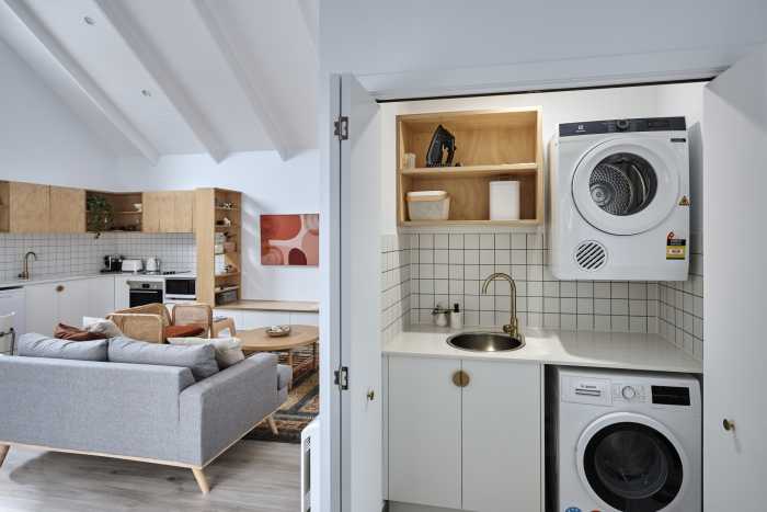 European Laundry with Modern Timber Shelving and Gold Tapware