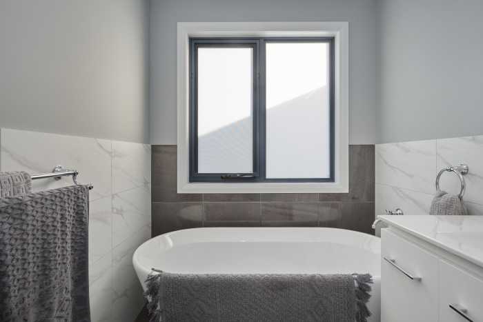 Grey and White Narrow Bathroom with Freestanding Bathtub