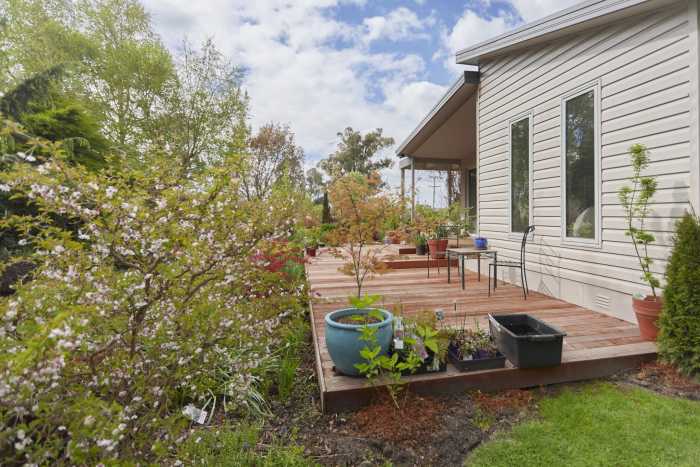 Deck extending out from Weatherboard Home