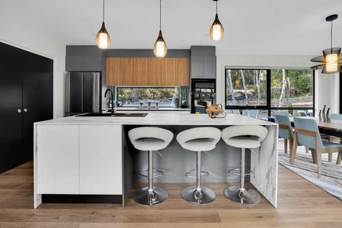 Contrasting Grey, Timber, and White Cabinetry with Modern Hanging Lights