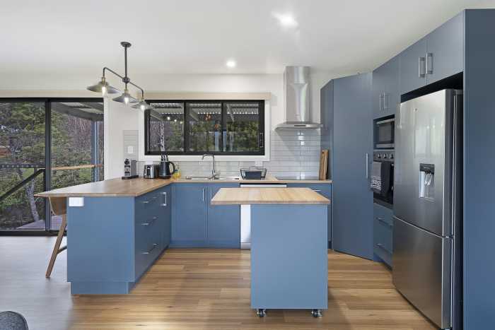 Unique Blue Kitchen with Timber Bench Top and Moveable Island Bench