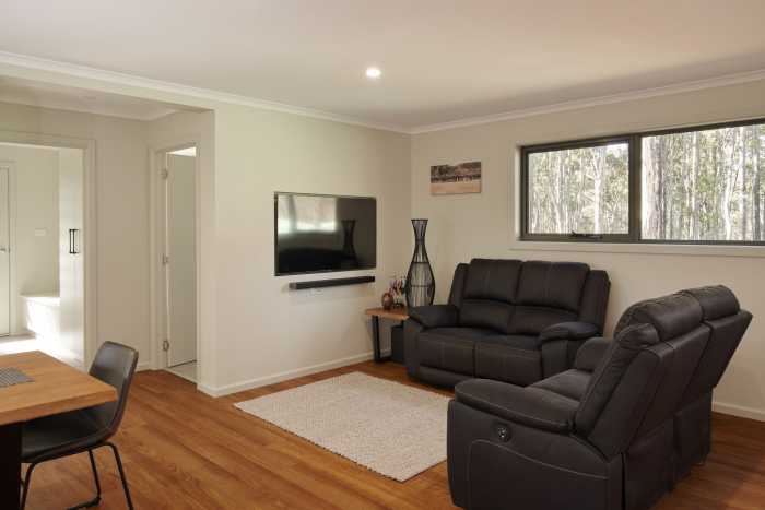 Small Living Room in Bush Home with Recessed TV