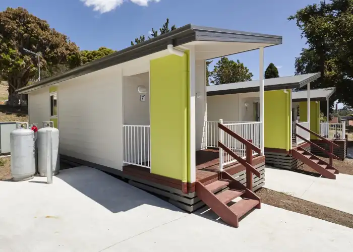 An external view of the front of a modern modular accommodation unit, with two identical units visible in the background.