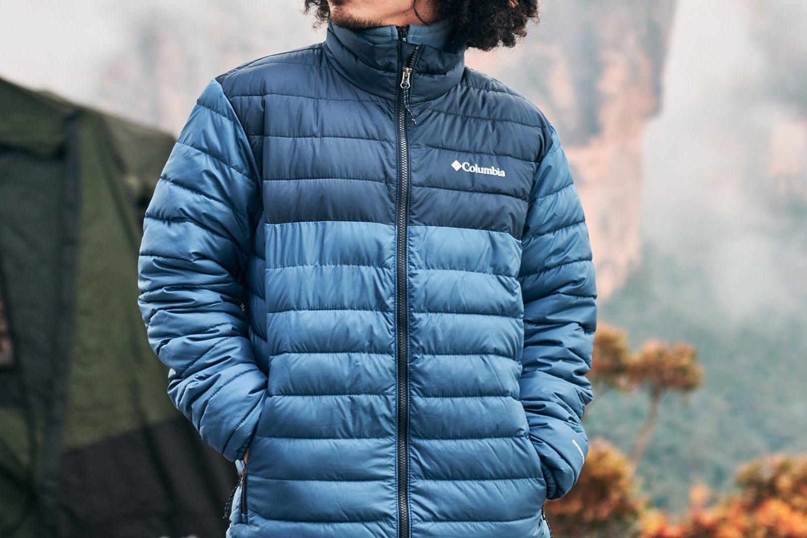 A man wearing a deep blue outdoor jacket demonstrates the type of durable gear suited to Tasmanian conditions.