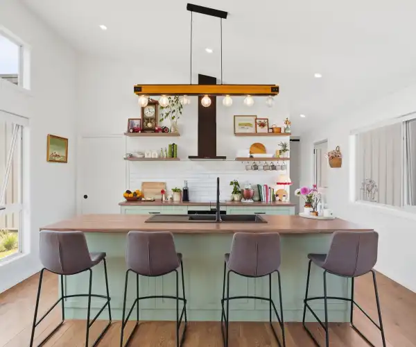 The contemporary kitchen features a spacious island bench and a functional layout that serves as the heart of the home.