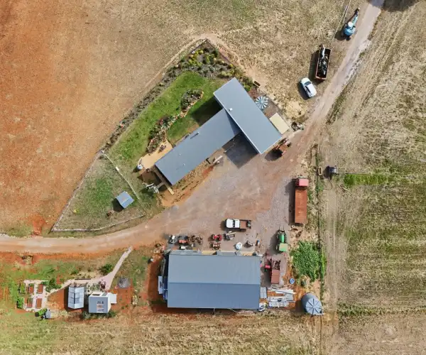 An aerial photograph looking down at the rooflines of the modular home, showing how the two construction stages have been integrated.