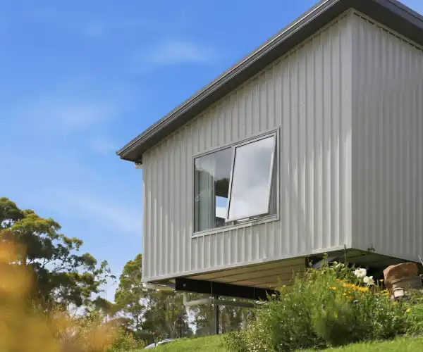 A detailed exterior photograph captures the house extension module that was added to create more living space for the growing family.